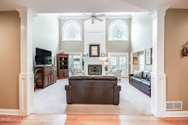 6516 Norman Ct, Crestwood, KY 40014 - living room with ornate columns, ceiling fan, a glass covered fireplace, crown molding, and a high ceiling