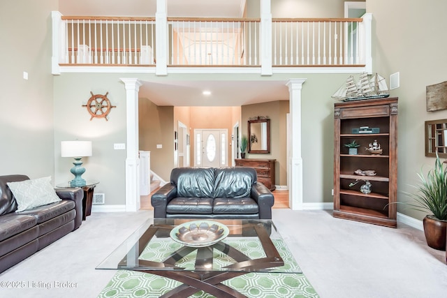 6516 Norman Ct, Crestwood, KY 40014 - living room featuring carpet floors, ornate columns, a towering ceiling, and baseboards