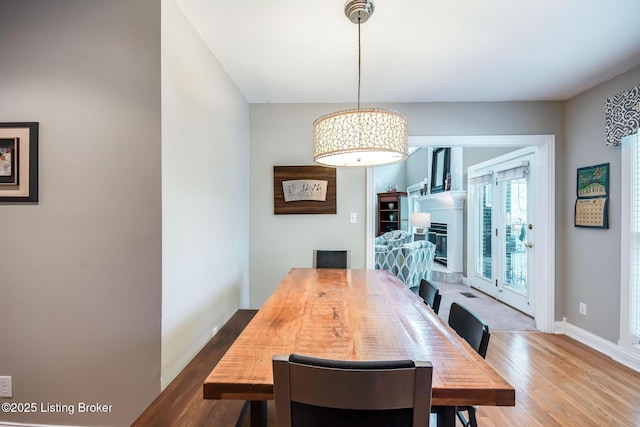 6516 Norman Ct, Crestwood, KY 40014 - dining area featuring wood finished floors, a glass covered fireplace, and baseboards