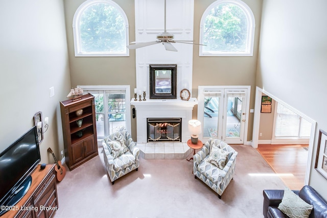 6516 Norman Ct, Crestwood, KY 40014 - living room featuring a tile fireplace, a high ceiling, a ceiling fan, and carpet floors