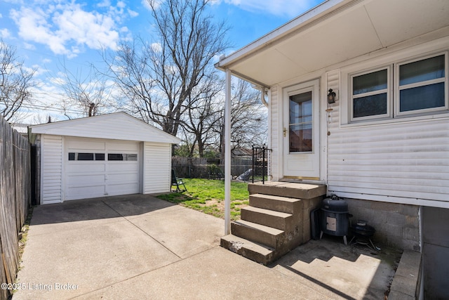 634 Ervay Ave, Louisville, KY 40217 - view of patio featuring an outbuilding, concrete driveway, and a detached garage