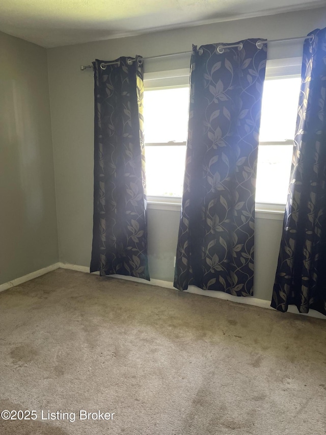 1310 Lacona Ln, Louisville, KY 40213 - carpeted empty room with healthy amount of natural light and baseboards