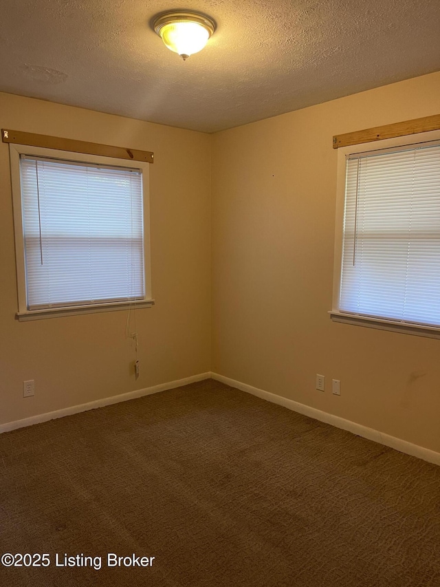 1310 Lacona Ln, Louisville, KY 40213 - spare room with a textured ceiling, dark carpet, and baseboards