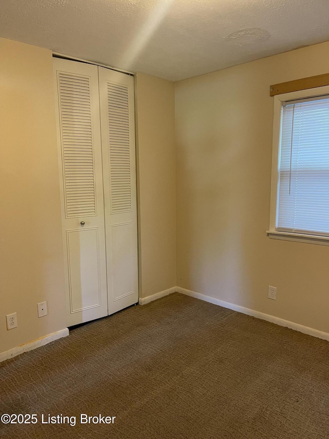 1310 Lacona Ln, Louisville, KY 40213 - unfurnished bedroom with dark carpet, a closet, and baseboards