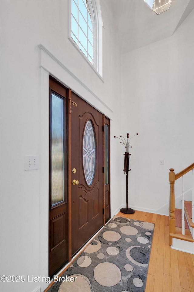 7911 Windgate Dr, Louisville, KY 40291 - entryway featuring hardwood / wood-style flooring, stairway, and a towering ceiling