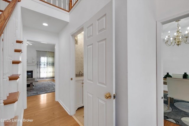 7911 Windgate Dr, Louisville, KY 40291 - hall featuring light wood-style floors, a chandelier, and recessed lighting