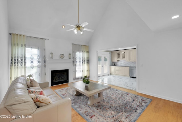 7911 Windgate Dr, Louisville, KY 40291 - living area with healthy amount of natural light, ceiling fan, high vaulted ceiling, french doors, and a fireplace
