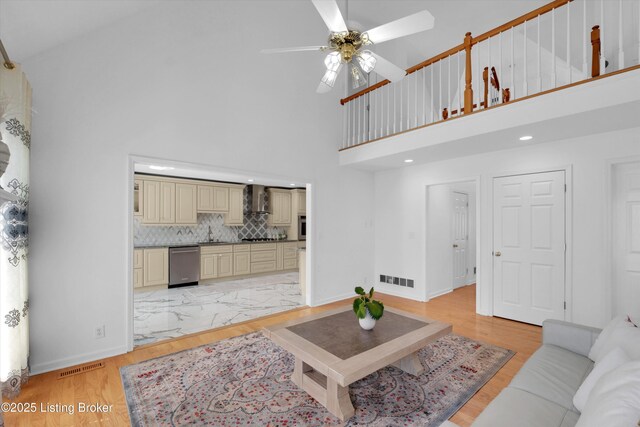 7911 Windgate Dr, Louisville, KY 40291 - living area featuring a high ceiling, a ceiling fan, baseboards, light wood-type flooring, and recessed lighting