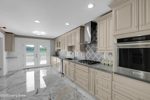7911 Windgate Dr, Louisville, KY 40291 - kitchen featuring wall chimney range hood, stainless steel appliances, cream cabinets, french doors, and a sink