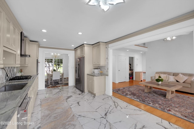 7911 Windgate Dr, Louisville, KY 40291 - kitchen with cream cabinets, appliances with stainless steel finishes, a sink, a chandelier, and backsplash