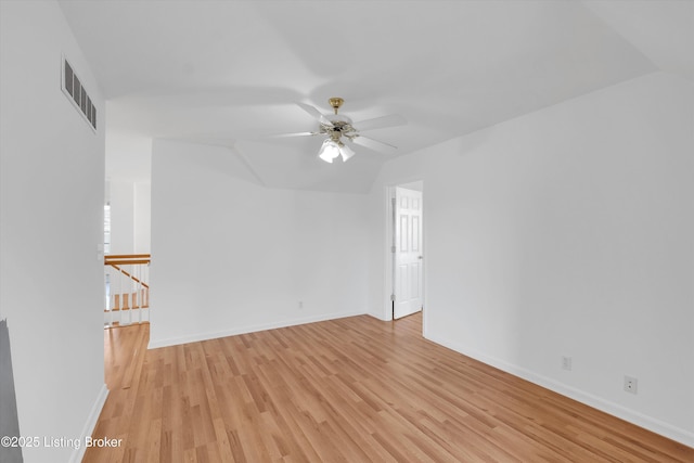 7911 Windgate Dr, Louisville, KY 40291 - empty room with light wood-style floors, ceiling fan, baseboards, and vaulted ceiling