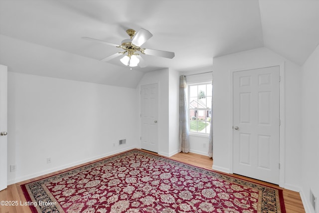 7911 Windgate Dr, Louisville, KY 40291 - bonus room featuring vaulted ceiling, wood finished floors, a ceiling fan, and baseboards