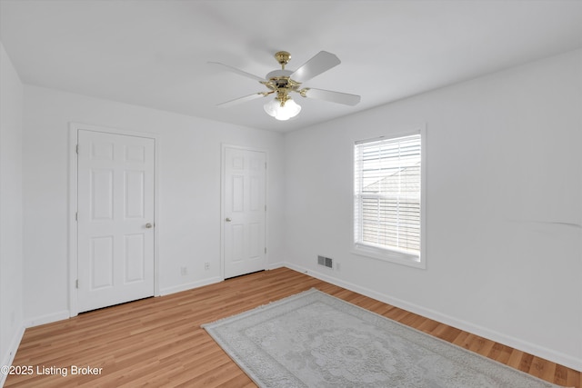 7911 Windgate Dr, Louisville, KY 40291 - empty room with light wood-style floors, a ceiling fan, and baseboards