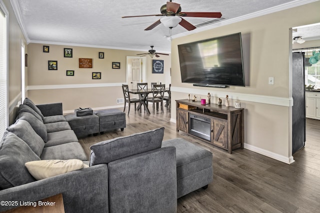 2010 Beech Grove Rd, Shepherdsville, KY 40165 - living area with ceiling fan, dark wood-type flooring, ornamental molding, a textured ceiling, and baseboards