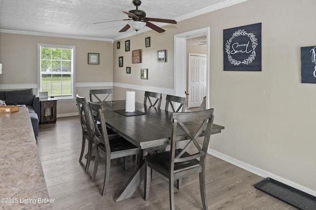2010 Beech Grove Rd, Shepherdsville, KY 40165 - dining room with wood finished floors, ceiling fan, ornamental molding, baseboards, and a textured ceiling