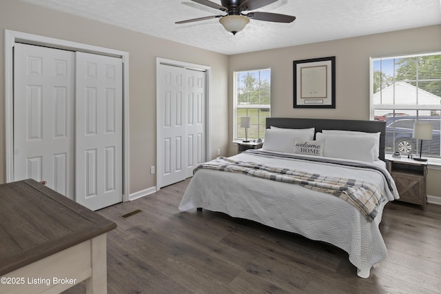 2010 Beech Grove Rd, Shepherdsville, KY 40165 - bedroom featuring multiple closets, dark wood-style floors, baseboards, a textured ceiling, and ceiling fan