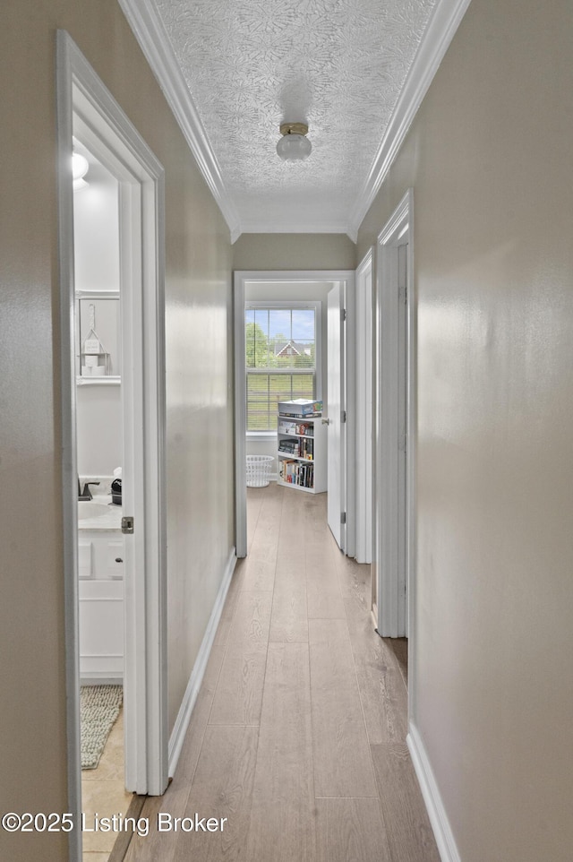 2010 Beech Grove Rd, Shepherdsville, KY 40165 - hallway featuring crown molding, a textured ceiling, baseboards, and wood finished floors