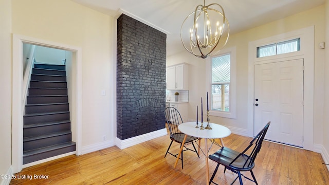 1228 S Floyd St, Louisville, KY 40203 - dining space featuring plenty of natural light, light wood finished floors, stairway, and a chandelier