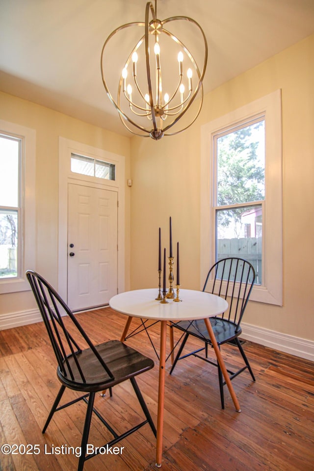 1228 S Floyd St, Louisville, KY 40203 - dining space featuring baseboards, hardwood / wood-style floors, and healthy amount of natural light