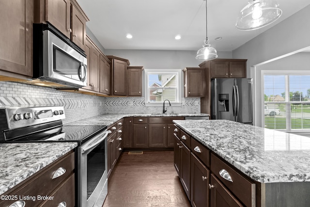 182 Washington Commons Dr, Mt Washington, KY 40047 - kitchen with appliances with stainless steel finishes, a sink, tasteful backsplash, dark wood-type flooring, and light stone countertops