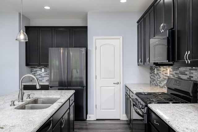 14341 Halden Ridge Way, Louisville, KY 40245 - kitchen featuring black microwave, gas range oven, a sink, freestanding refrigerator, and dark cabinetry
