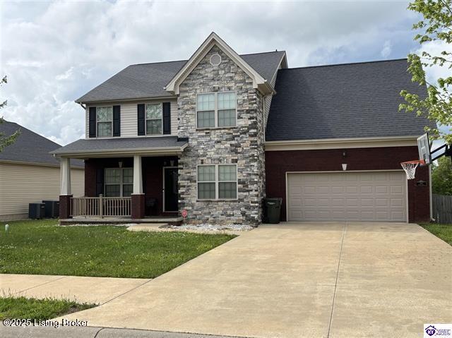 218 Sangria Dr, Vine Grove, KY 40175 - view of front facade featuring a porch, stone siding, driveway, a front lawn, and a garage