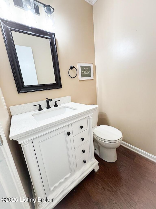 8602 Banbridge Rd, Louisville, KY 40242 - bathroom with toilet, wood finished floors, vanity, and baseboards