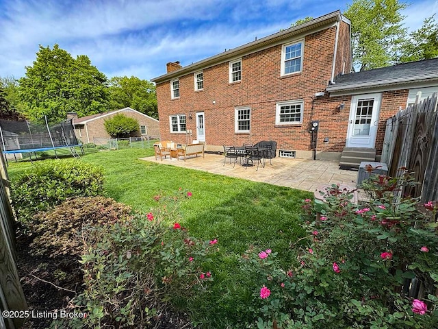 8602 Banbridge Rd, Louisville, KY 40242 - rear view of house with entry steps, a trampoline, a patio, and a chimney