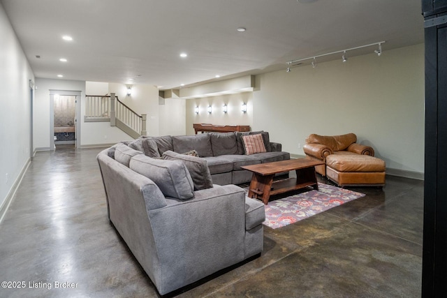 living room featuring finished concrete flooring, stairway, recessed lighting, and baseboards