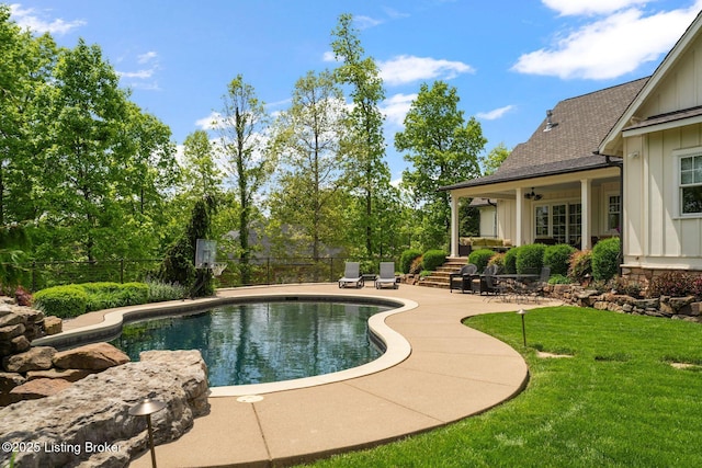 view of pool with a patio area and a ceiling fan