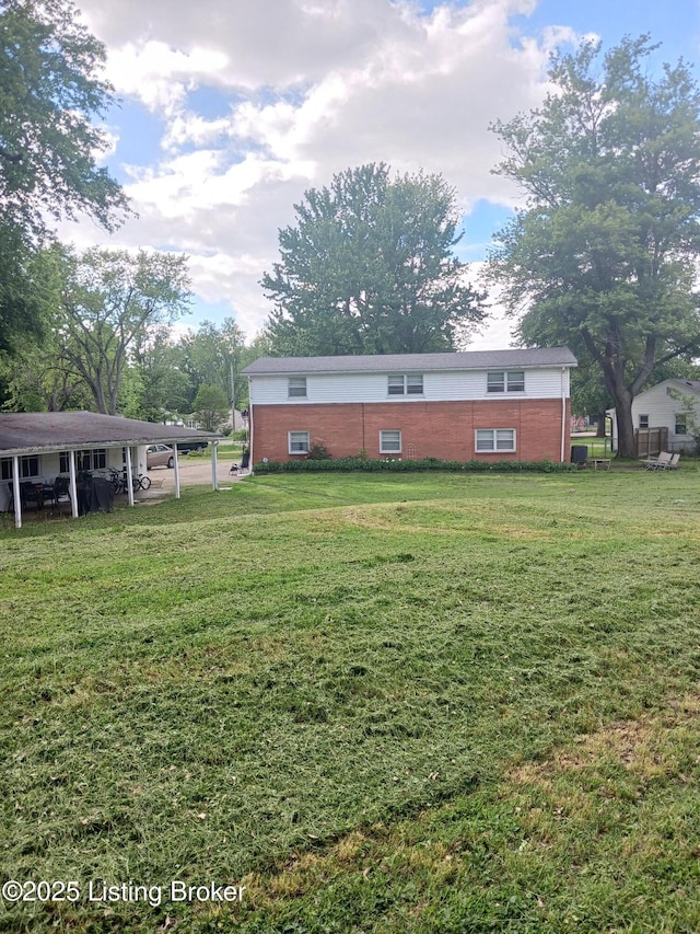 7702 Edna M Rd, Louisville, KY 40258 - view of grassy yard with a carport