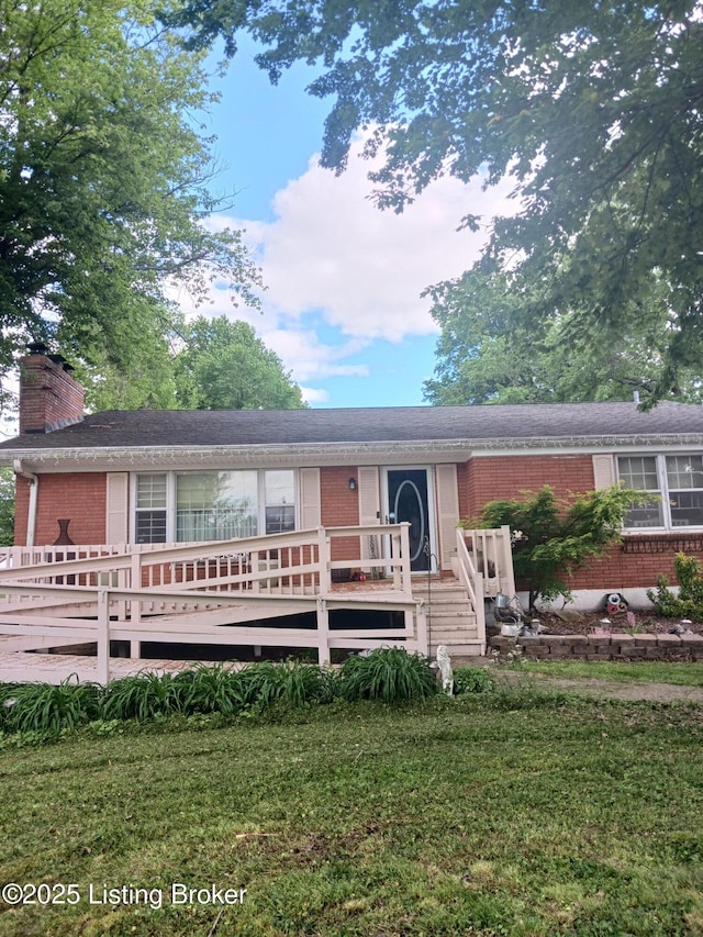 7702 Edna M Rd, Louisville, KY 40258 - ranch-style house with brick siding, a deck, a chimney, and a front lawn