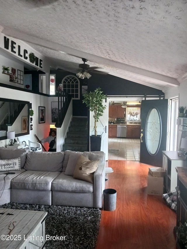 7702 Edna M Rd, Louisville, KY 40258 - living area with lofted ceiling, ceiling fan, stairway, wood finished floors, and a textured ceiling