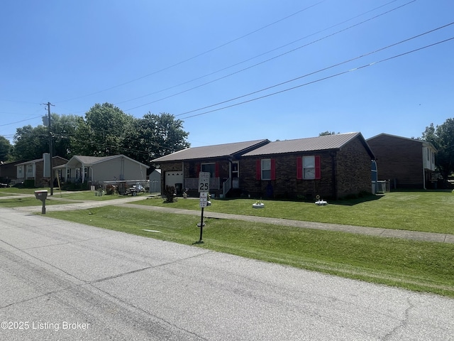 100 Monroe St, Radcliff, KY 40160 - view of front of property with an attached garage, a front yard, driveway, and a metal roof