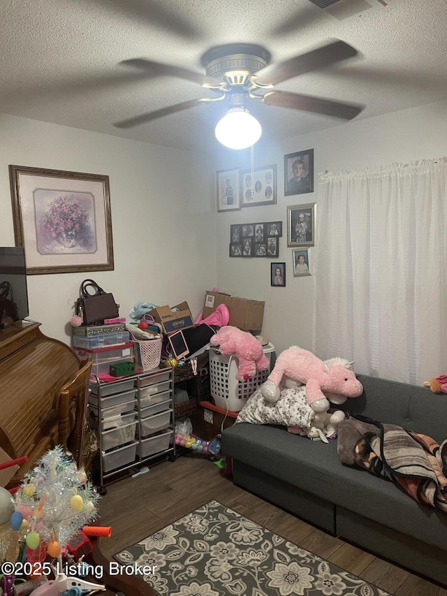 100 Monroe St, Radcliff, KY 40160 - bedroom featuring wood finished floors, a textured ceiling, and a ceiling fan
