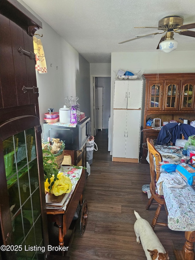 100 Monroe St, Radcliff, KY 40160 - dining area with ceiling fan, dark wood finished floors, and a textured ceiling