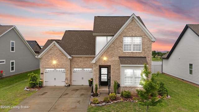 traditional home with brick siding, concrete driveway, roof with shingles, and a front lawn