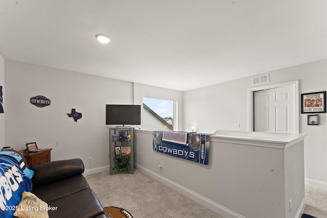 carpeted living room with baseboards