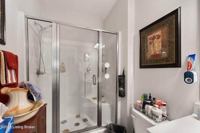 bathroom featuring a stall shower, vanity, and toilet