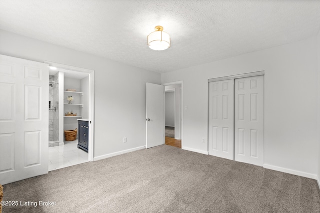 3304 S Camden Ln, Crestwood, KY 40014 - unfurnished bedroom featuring carpet floors, a closet, baseboards, a textured ceiling, and ensuite bath