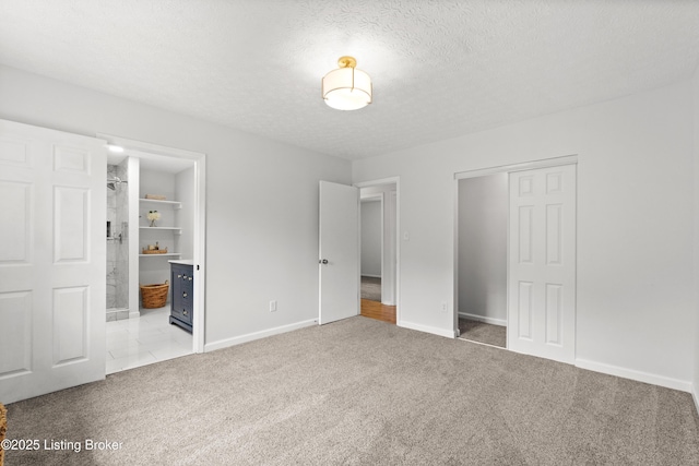 3304 S Camden Ln, Crestwood, KY 40014 - unfurnished bedroom featuring a closet, carpet flooring, baseboards, a textured ceiling, and connected bathroom