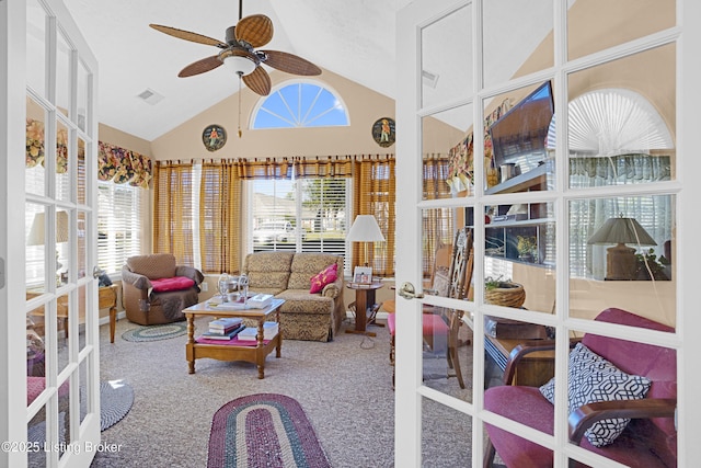 carpeted living room featuring french doors, ceiling fan, and high vaulted ceiling