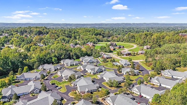 aerial view of property's location with nearby suburban area and a forest
