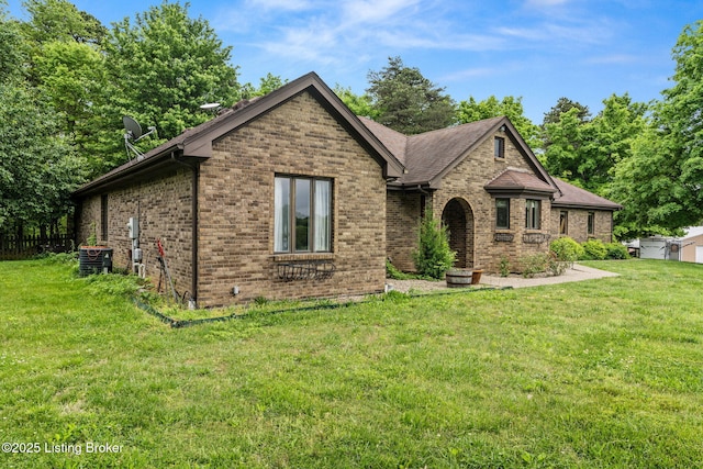 1093 W Bryan Rd, Elizabethtown, KY 42701 - view of front of home with brick siding, a front lawn, and central AC