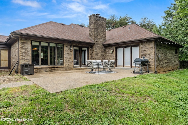 1093 W Bryan Rd, Elizabethtown, KY 42701 - rear view of property with brick siding, a yard, a chimney, a patio, and central AC