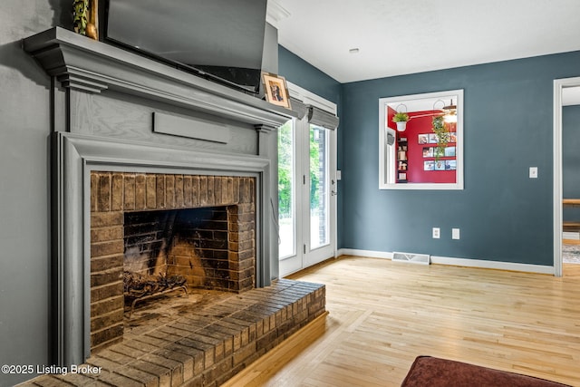1093 W Bryan Rd, Elizabethtown, KY 42701 - living room featuring baseboards, light wood-style flooring, and a fireplace