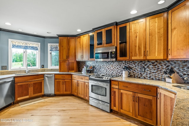 1093 W Bryan Rd, Elizabethtown, KY 42701 - kitchen featuring appliances with stainless steel finishes, a sink, brown cabinetry, light wood-style flooring, and light stone counters