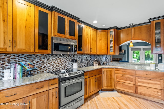 1093 W Bryan Rd, Elizabethtown, KY 42701 - kitchen with appliances with stainless steel finishes, light stone countertops, glass insert cabinets, brown cabinetry, and recessed lighting