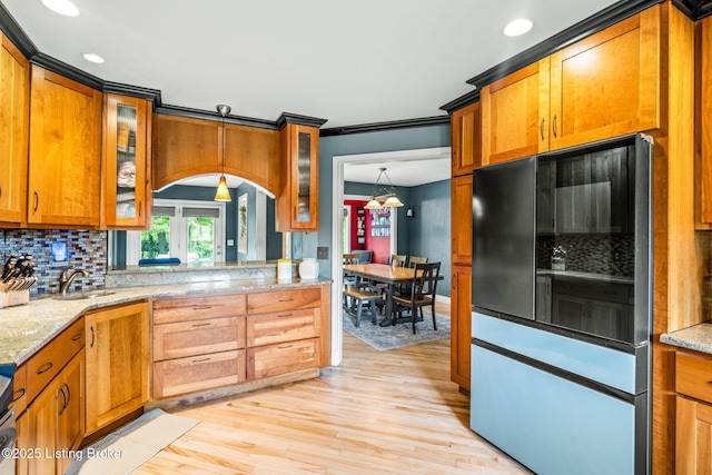1093 W Bryan Rd, Elizabethtown, KY 42701 - kitchen with brown cabinets, decorative backsplash, light wood-style flooring, recessed lighting, and a sink