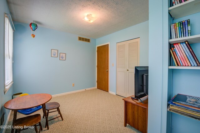 7003 Red Plum Ter, Pewee Valley, KY 40056 - living area with carpet, baseboards, and a textured ceiling